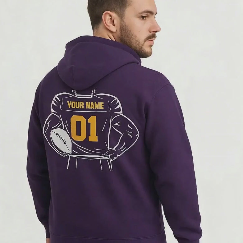 Video of a man wearing a purple hoodie with a customizable football design on a white background